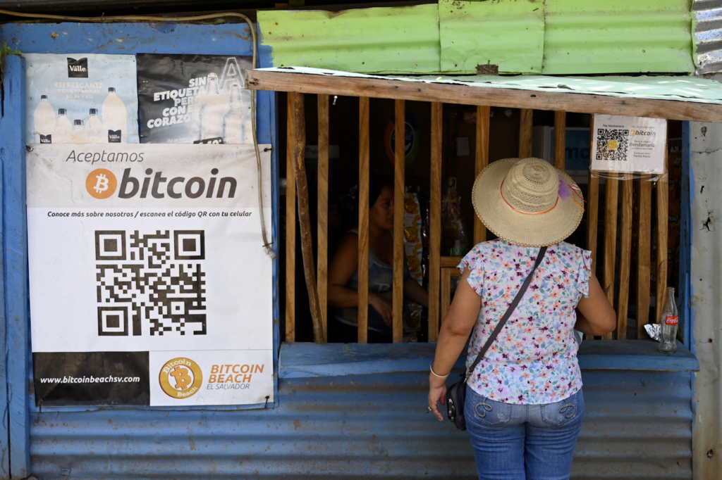 El Salvador - a woman stands in front of a Bitcoin vendor